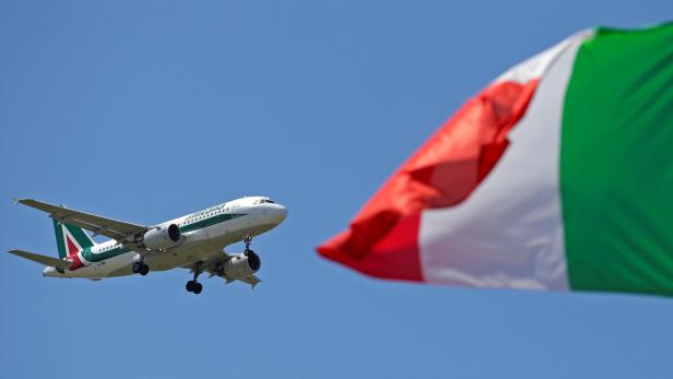 An Italy flag flutters as an Alitalia airplane approaches to land at Fiumicino airport in Rome, Italy, July 31, 2014. REUTERS/Max Rossi/File Photo