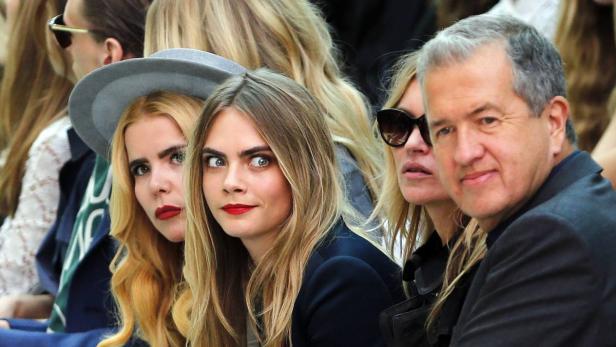 Mit keckem Hut getarnt und blutroten Lippen zeigte sich Sängerin Paloma Faith (l.) neben Topmodel Cara Delevingne, Kate Moss und Fotograf Mario Testino bei der Burberry-Schau in London.