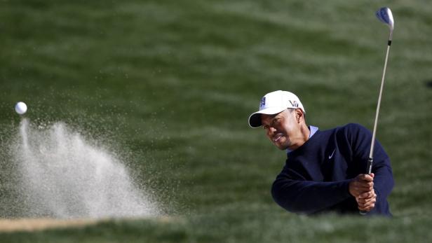 Tiger Woods of the U.S. hits from the sand during a practice round for the WGC-Accenture Match Play Championship golf tournament in Marana, Arizona February 19, 2013. REUTERS/Matt Sullivan (UNITED STATES - Tags: SPORT GOLF)