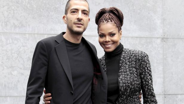 U.S. singer Janet Jackson (R) and her then boyfriend Wissam Al Mana pose for photographers as they arrive to attend the Giorgio Armani Autumn/Winter 2013 collection at Milan Fashion Week, in this file picture taken February 25, 2013. Hinting at a possible pregnancy, Janet Jackson announced on April 6, 2016 that she was temporarily halting her world tour because of a &quot;sudden change&quot; that required her and her husband to plan a family. REUTERS/Alessandro Garofalo/Files