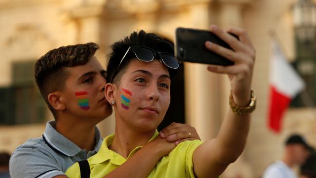 People take a selfie while celebrating after the Maltese parliament voted to legalise same-sex marriage on the Roman Catholic Mediterranean island, in Valletta, Malta July 12, 2017. REUTERS/Darrin Zammit Lupi
