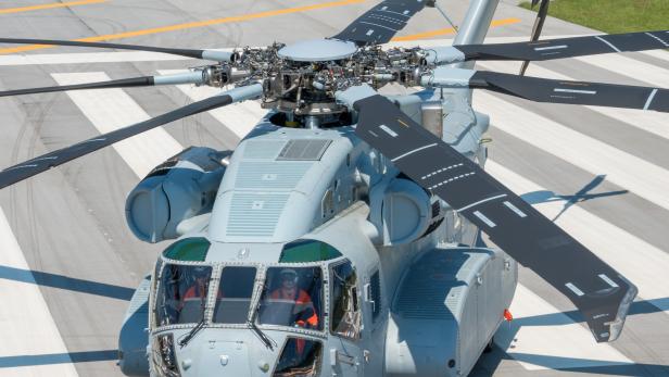Ein grauer Militärhubschrauber steht auf einem Rollfeld.