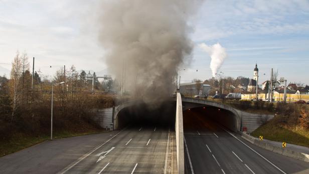 Dichter Rauch dringt aus einem Autobahntunnel.