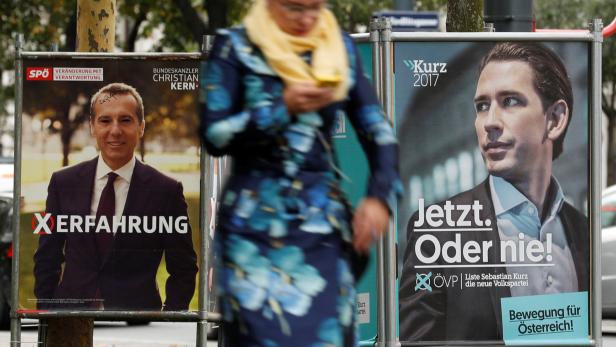 Election campaign posters of the SPOe showing Chancellor Christian Kern and of the OeVP showing Vice Chancellor Sebastian Kurz are seen in Vienna, Austria, October 6, 2017. REUTERS/Heinz-Peter Bader
