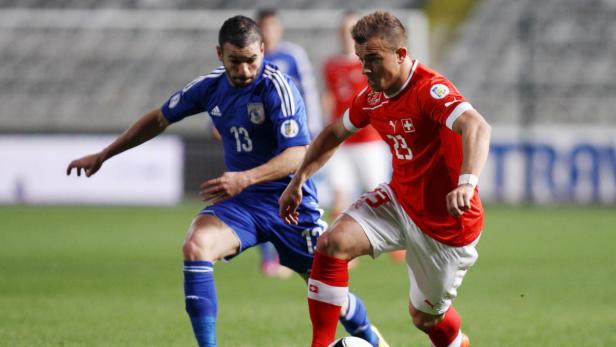 epa03638186 Switzerland&#039;s Xherdan Shaqiri (R) vies for the ball with Cyprusís Constantinos Makridis (L) during their FIFA World Cup 2014 qualifying match Cyprus vs Switzerland at the GSP Stadium, Nicosia, Cyprus, 23 March 2013. EPA/-