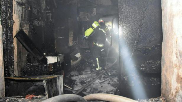 Die Einsatzkräfte der Feuerwehr in der völlig zerstörten Wohnung.