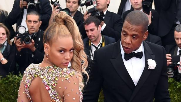 (FILES) This file photo taken on May 4, 2015 shows Beyonce and Jay Z arriving at the Metropolitan Museum of Art&#039;s Costume Institute Gala benefit in honor of the museumÕs latest exhibit ÒChina: Through the Looking GlassÓ in New York. Jay-Z&#039;s jaunty anthems made him one of rap&#039;s all-time greats and then, as he amassed a business empire and married fellow superstar Beyonce, he drew an ever thicker curtain over his private life.Releasing an album after a four-year gap, Jay-Z has bared himself like rarely before. He apologizes to Beyonce for cheating and pours out love for his mother whom he reveals to be lesbian, all while taking familiar but timely shots on the politics of race.&quot;4:44,&quot; the 13th studio album by the rapper born as Shawn Carter, came out June 30, 2017 as an exclusive on his upstart Tidal streaming service whose new part-owners, telecom provider Sprint, is banking on the release to woo customers. / AFP PHOTO / Timothy A. CLARY