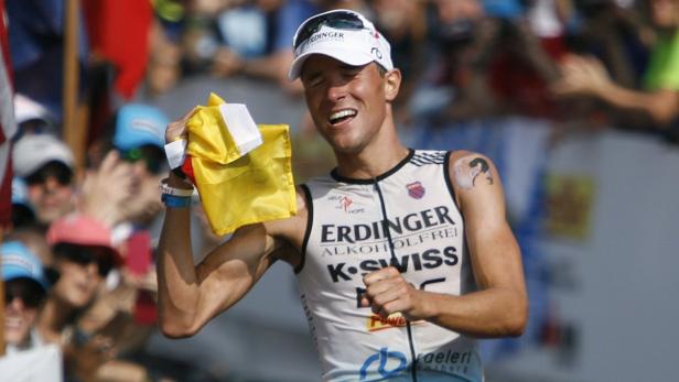 Professional triathlete Andreas Raelert of Germany celebrates after getting second place after the finishing the Ironman World Championship triathlon in Kailua-Kona, Hawaii, October 13, 2012. REUTERS/Hugh Gentry (UNITED STATES - Tags: SPORT TRIATHLON)