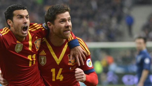 epa03641865 Pedro Rodriguez (L) of Spain is congratulated by teammate Xavi Alonso (R) after scoring the 1-0 goal during the FIFA World Cup 2014 qualifying soccer match between France and Spain at the Stade de France Stadium, in Saint-Denis, near, Paris, 26 March 2013. EPA/CHRISTOPHE KARABA