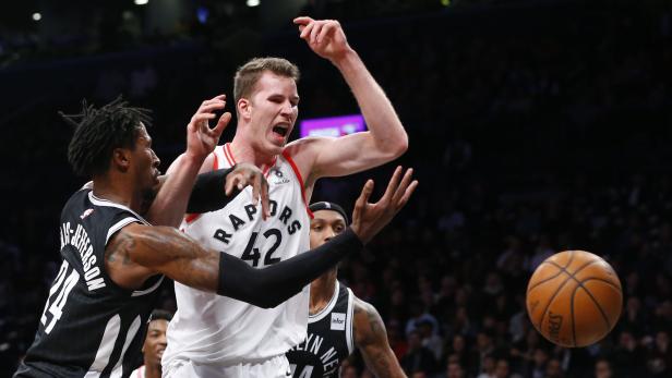 Mar 13, 2018; Brooklyn, NY, USA; Toronto Raptors center Jakob Poeltl (42) loses the ball as Brooklyn Nets forward Rondae Hollis-Jefferson (24) defends during first half at Barclays Center. Mandatory Credit: Noah K. Murray-USA TODAY Sports