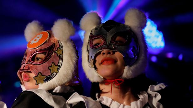 Members of Japan&#039;s idol group &quot;Virtual Currency Girls&quot; wearing cryptocurrency-themed masks perform in their debut stage event in Tokyo, Japan, January 12, 2018. REUTERS/Kim Kyung-Hoon