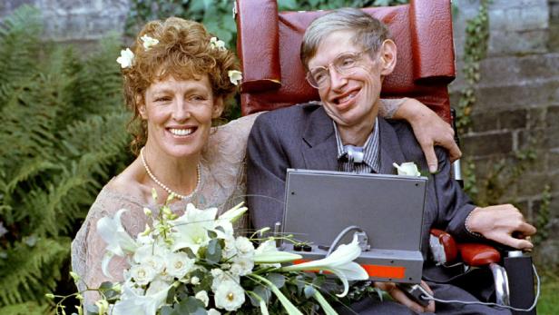 FILE PHOTO: Stephen Hawking and his new bride Elaine Mason pose for pictures after the blessing of their wedding at St. Barnabus Church September 16, 1995. REUTERS/Russell Boyce/File Photo