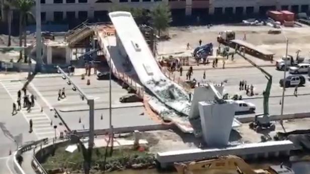 Emergency crews work at the scene of a collapsed pedestrian bridge at Florida International University in Miami, Florida March 15, 2018 in this still image obtained from social media video. Instagram/ @BRANDONX868 via REUTERS ATTENTION EDITORS - THIS IMAGE WAS PROVIDED BY A THIRD PARTY. NO RESALES. NO ARCHIVES. MANDATORY CREDIT: @BRANDONX868