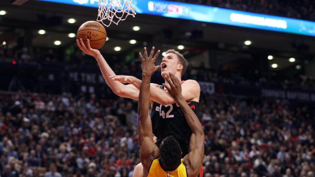 Dec 1, 2017; Toronto, Ontario, CAN; Toronto Raptors center Jakob Poeltl (42) is fouled as he goes to the basket against Indiana Pacers forward Thaddeus Young (21) at Air Canada Centre. The Raptors beat the Pacers 120-115. Mandatory Credit: Tom Szczerbowski-USA TODAY Sports