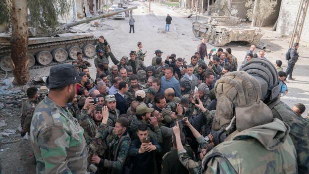 Syrian President Bashar al-Assad meets with Syrian army soldiers in eastern Ghouta, Syria, March 18, 2018. SANA/Handout via REUTERS ATTENTION EDITORS - THIS IMAGE HAS BEEN SUPPLIED BY A THIRD PARTY. REUTERS IS UNABLE TO INDEPENDENTLY VERIFY THIS IMAGE.