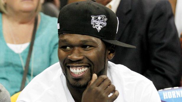 File phot of 50 Cent sitting courtside during bask