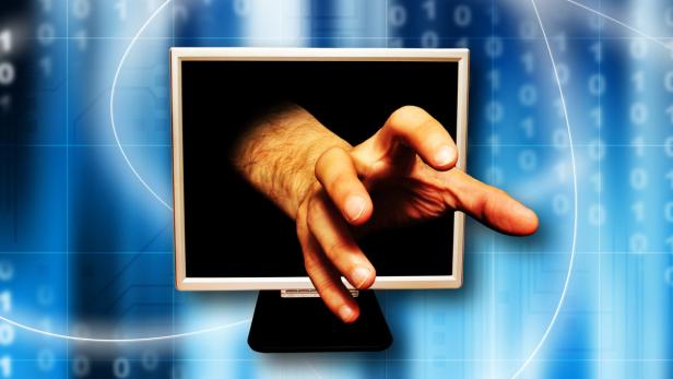 hand coming out of a computer monitor screen as concept for internet crime