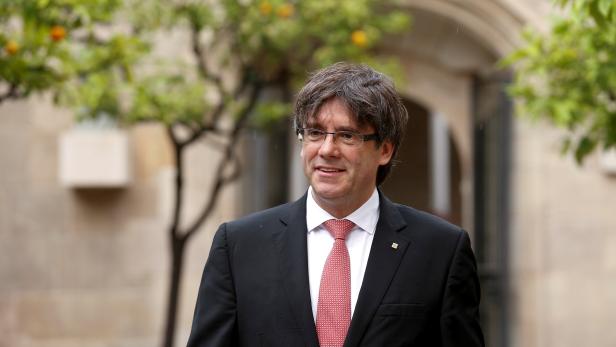 Catalonia's regional President Carles Puigdemont arrives for a meeting at the Palau de la Generalitat, the regional government headquarters, in Barcelona