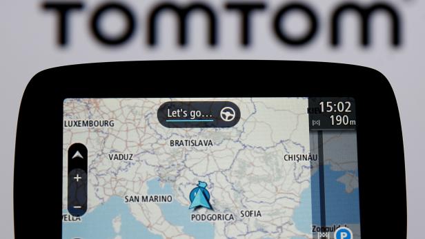 FILE PHOTO: TomTom navigation are seen in front of TomTom displayed logo in this illustration taken