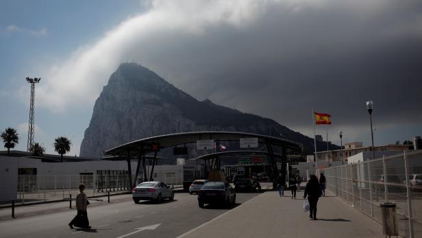 People enter the British territory of Gibraltar, historically claimed by Spain, at its border with Spain, in La Linea de la Concepcion