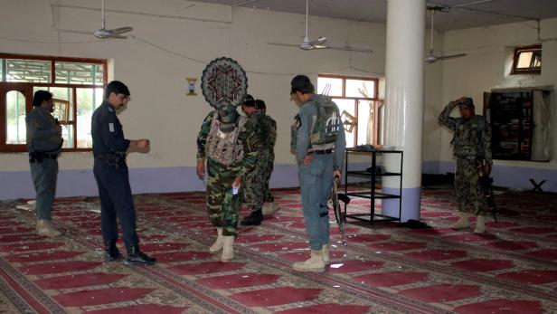 Afghanische Polizisten inspizieren die Moschee nach der Explosion
