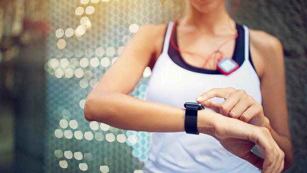 Runner girl is checking her smart watch
