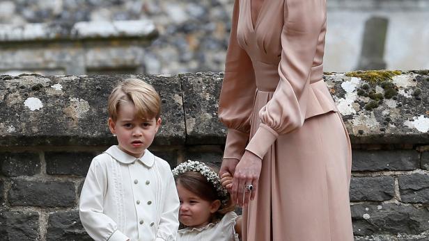 Catherine, Duchess of Cambridge, stands with Princess Charlotte and Prince George, who were flower boys and girls at the wedding of Pippa Middleton and James Matthews at St Mark's Church in Englefield
