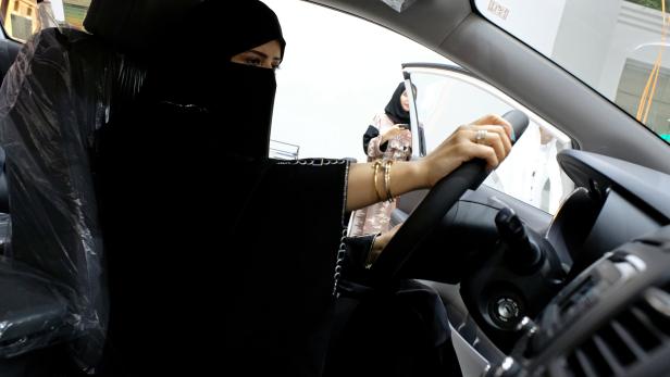 FILE PHOTO: A Saudi woman checks a car  at the first automotive showroom solely dedicated for women in Jeddah