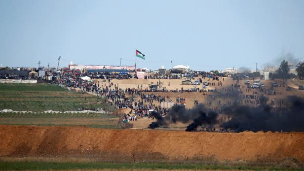 Smoke rises as Palestinians protest near the border fence on the Gaza side of the Israel-Gaza border, as seen from the Israeli side of the border