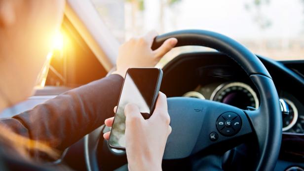 businesswoman texting while driving