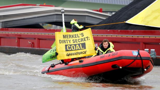 Activists hold a banner during a protest on the Rhein river organised by the environmental organisation Greenpeace during COP23 U.N. Climate Change Conference in Bonn