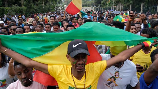 Ethiopians carry their national flag during a rally in support of the new Prime Minister Abiy Ahmed in Addis Ababa
