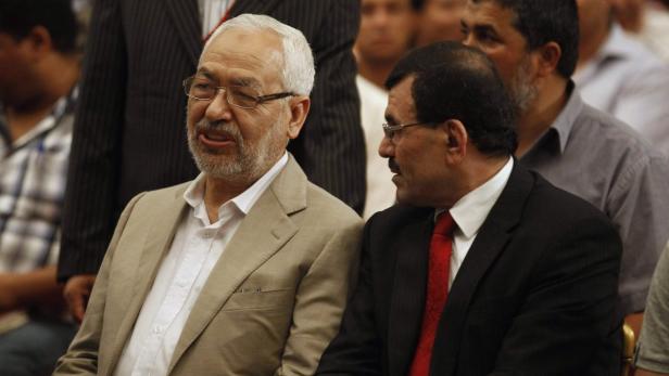 Ennahda movement leader Ghannouchi speaks with Tun