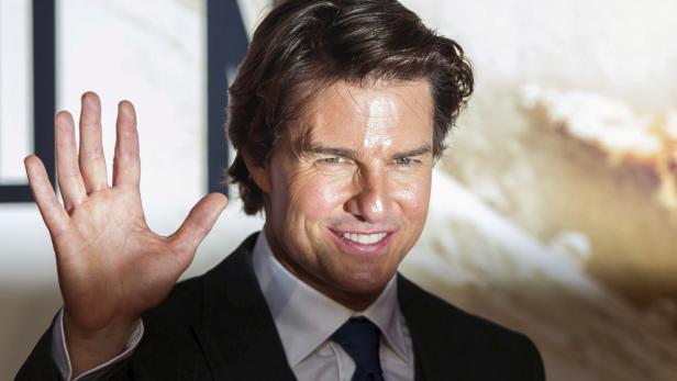 FILE PHOTO: U.S. actor Tom Cruise poses for photographers at a British screening of the film "Mission Impossible: Rogue Nation" in London, Britain