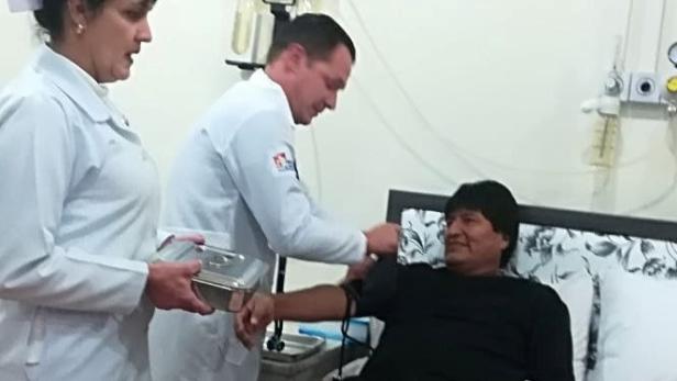 A doctor examines Bolivia's President Evo Morales during his annual health check in La Pa