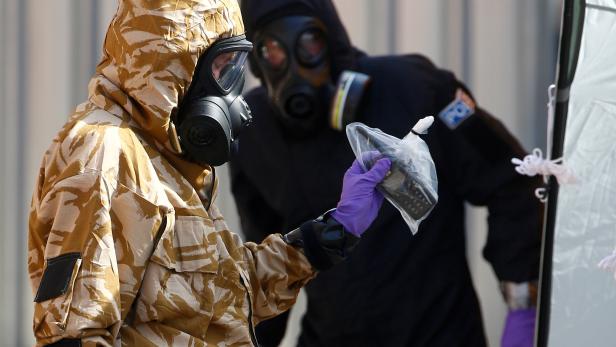 FILE PHOTO: Forensic investigators, wearing protective suits, emerge from the rear of John Baker House, after it was confirmed that two people had been poisoned with the nerve-agent Novichok, in Amesbury