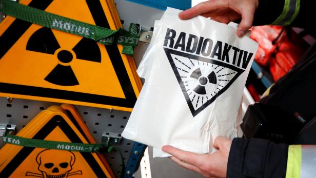 A firefighter display an radioactive sign during an emergency drill called "Gamma 2017" to practise their response in case of a radioactive incident at the Helmholtz nuclear research reactor in Berlin