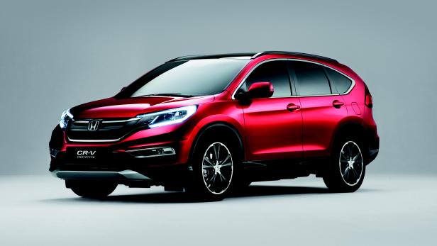 Ein roter Honda CR-V vor einem grauen Hintergrund.