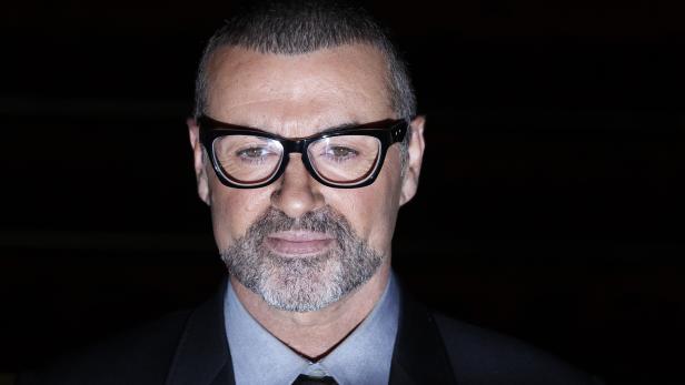 FILE PHOTO - British singer George Michael poses for photographers before a news conference at the Royal Opera House in central London