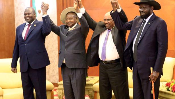 FILE PHOTO: Sudan's President Omar Al-Bashir hold hands with Uganda's President Yoweri Museveni, South Sudan's President Salva Kiir and South Sudan rebel leader Riek Machar during a South Sudan peace meeting in Khartoum
