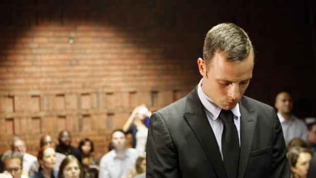 Oscar Pistorius stands in the dock during a break in court proceedings at the Pretoria Magistrates court, February 20, 2013. &quot;Blade Runner&quot; Pistorius, a double amputee who became one of the biggest names in world athletics, was applying for bail after being charged in court with shooting dead his girlfriend, 30-year-old model Reeva Steenkamp, in his Pretoria house. REUTERS/Siphiwe Sibeko (SOUTH AFRICA - Tags: CRIME LAW SPORT TPX IMAGES OF THE DAY)
