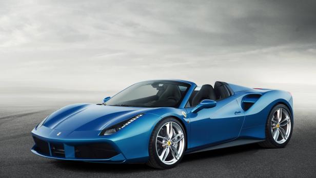 Ein blauer Ferrari 488 Spider vor einem bewölkten Himmel.