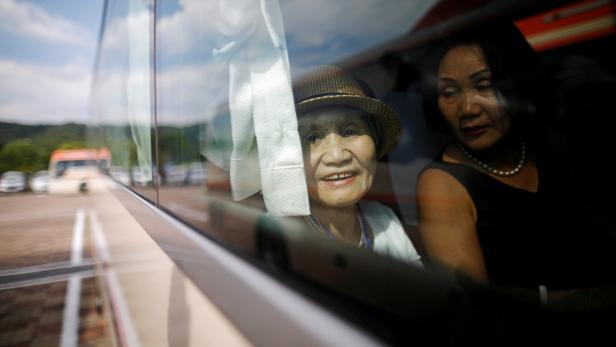A South Korean participant for a reunion sits inside a bus as she arrives at the South's CIQ (Customs, Immigration and Quarantine), just south of the DMZ in Goseong