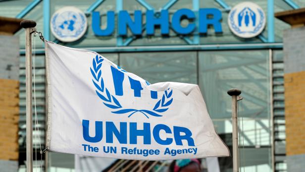 A flag is pictured in front of the UNHCR headquarters in Geneva