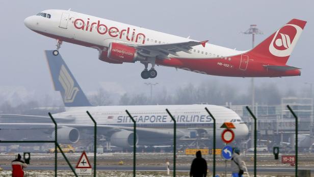 Plane spotters watch an Airbus A320-214 passenger