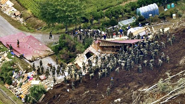 Members of JSDF search for survivors from a house damaged by a landslide caused by an earthquake in Atsuma town