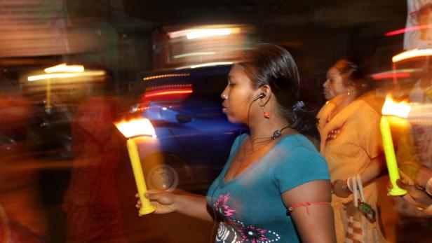 epa03201697 Indian sex workers and their children walk with candels during a May Day rally organise by Durbar Mahila Samanwaya Committee in the Eastern Indian city of Calcutta, 30 April 2012. The 123rd International Labour day is celebrated all over the country on 01 May. EPA/PIYAL ADHIKARY