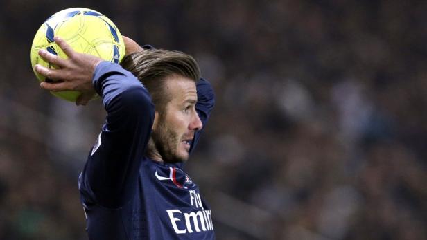 David Beckham mit einem gelben Fußball in den Händen.