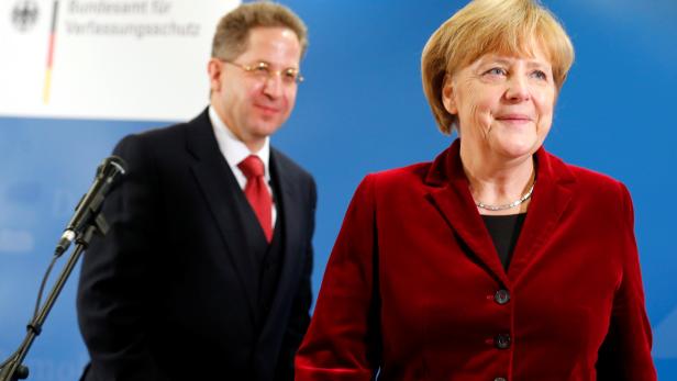 FILE PHOTO: German Chancellor Merkel and Maassen, president of BfV, federal domestic intelligence service, leave BfV's headquarters following their meeting in Cologne
