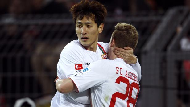Augsburg's Ji and Hahn celebrate a goal against Borussia Dortmund during the German first division Bundesliga soccer match in Dortmund